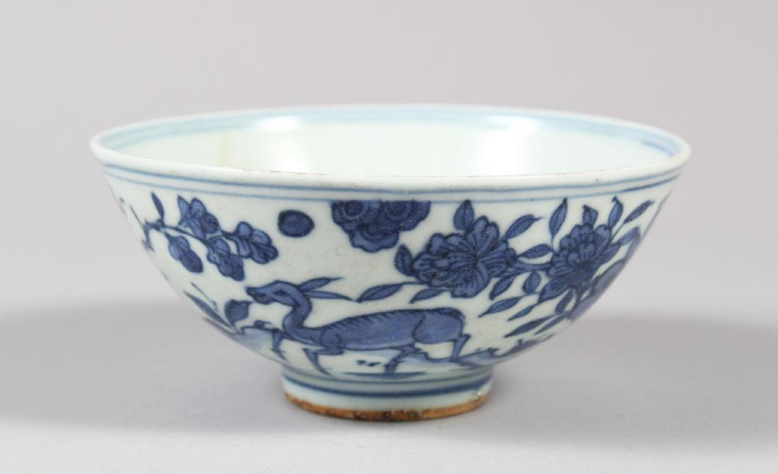 A CHINESE BLUE AND WHITE PORCELAIN RICE BOWL, decorated: A CHINESE BLUE AND WHITE PORCELAIN RICE BOWL, decorated with deer and birds, six-character mark to base, 12.6cm tall, 5.6cm wide.