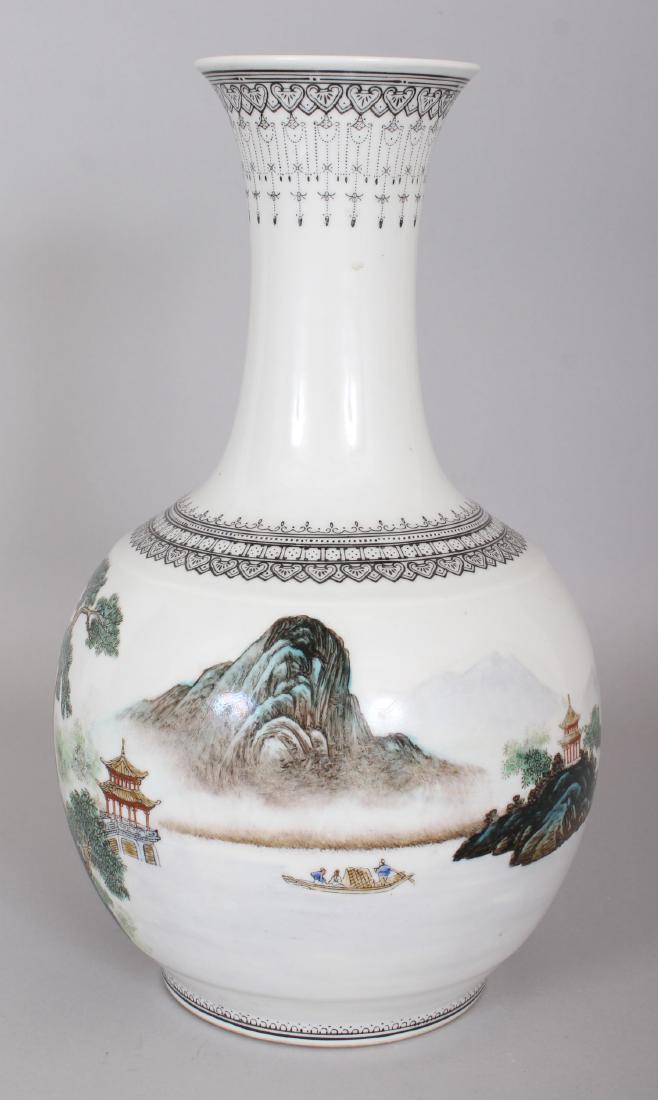 A 20TH CENTURY CHINESE FAMILLE ROSE PORCELAIN BOTTLE: A 20TH CENTURY CHINESE FAMILLE ROSE PORCELAIN BOTTLE VASE, the sides painted with a continuous river landscape scene, the base with a red four-character mark, 28.5cm high.