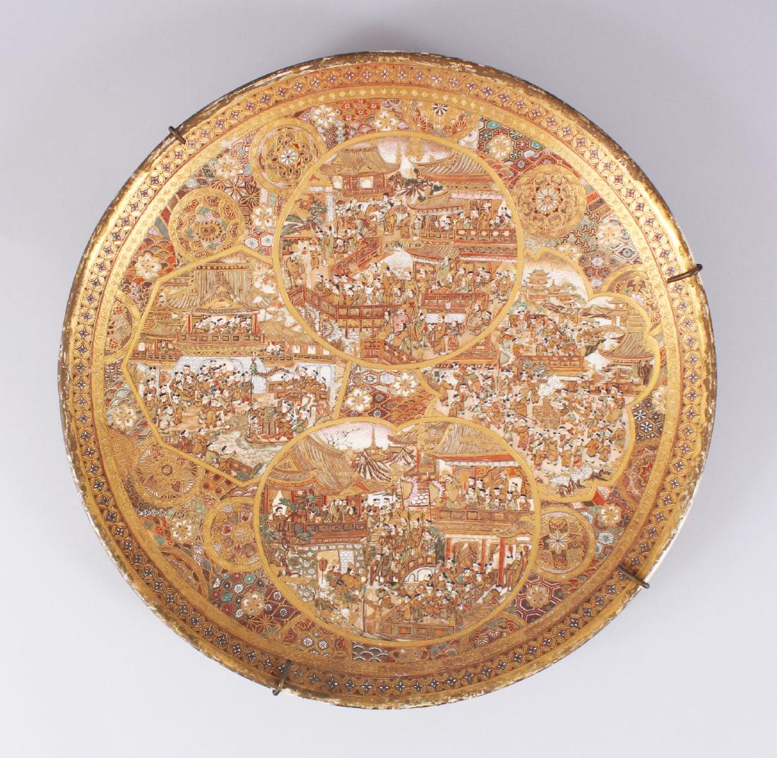 A FINELY DECORATED JAPANESE MEIJI PERIOD SATSUMA: A FINELY DECORATED JAPANESE MEIJI PERIOD SATSUMA CHARGER / DISH, very intricately decorated with gilt and enamel paint depicting many scenes of immortals within temples and garden settings, the outer 