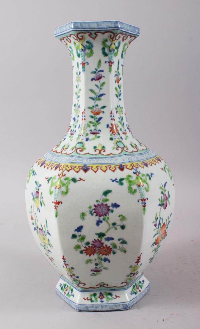A CHINESE FAMILLE ROSE HEXAGONAL SHAPE PORCELAIN VASE,: A CHINESE FAMILLE ROSE HEXAGONAL SHAPE PORCELAIN VASE, the vase decorated with various floral displays, the rim & foot rim with a Greek key border, the base with a six-character mark, possibly late 19