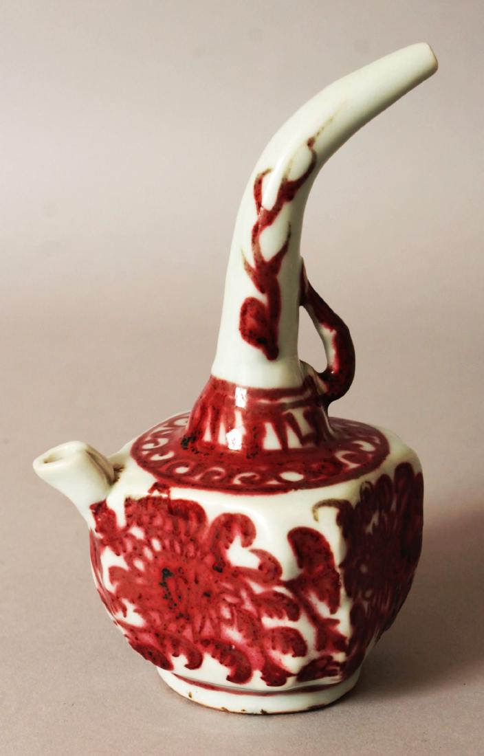 AN UNUSUAL CHINESE MING STYLE COPPER-RED COMBINED WATER: AN UNUSUAL CHINESE MING STYLE COPPER-RED COMBINED WATER DROPPER & EWER, the hollow handle forming the water dropper, the sides decorated with formal foliage,15.8cm high.