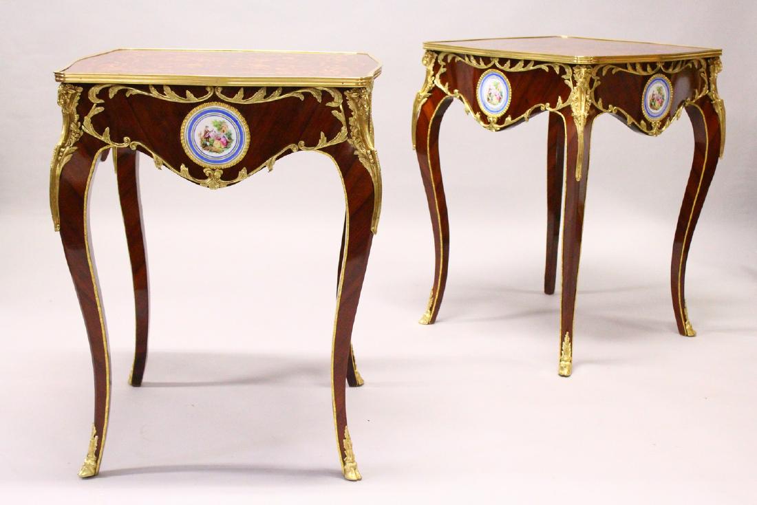 A PAIR OF FRENCH STYLE MARQUETRY AND ORMOLU CENTRE: A PAIR OF FRENCH STYLE MARQUETRY AND ORMOLU CENTRE TABLES, each inset with porcelain panels, on cabriole legs. 61cms x 61cms x 77cms high.