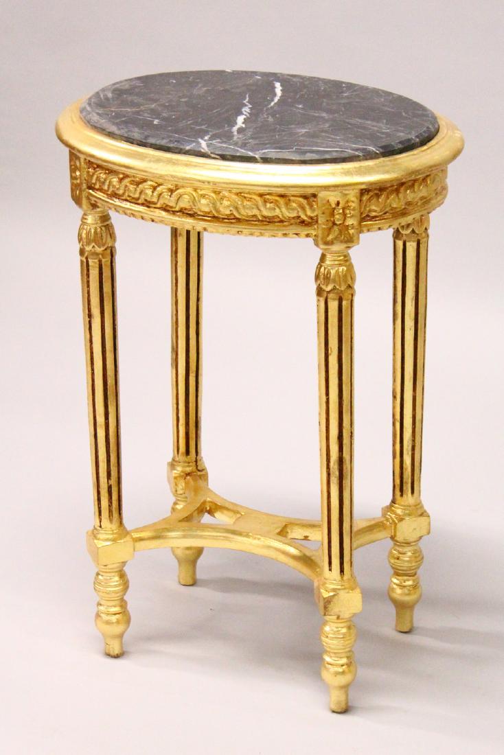 A FRENCH STYLE GILTWOOD OVAL TABLE, inset with a black: A FRENCH STYLE GILTWOOD OVAL TABLE, inset with a black marble top. 50cms wide x 72cms high.