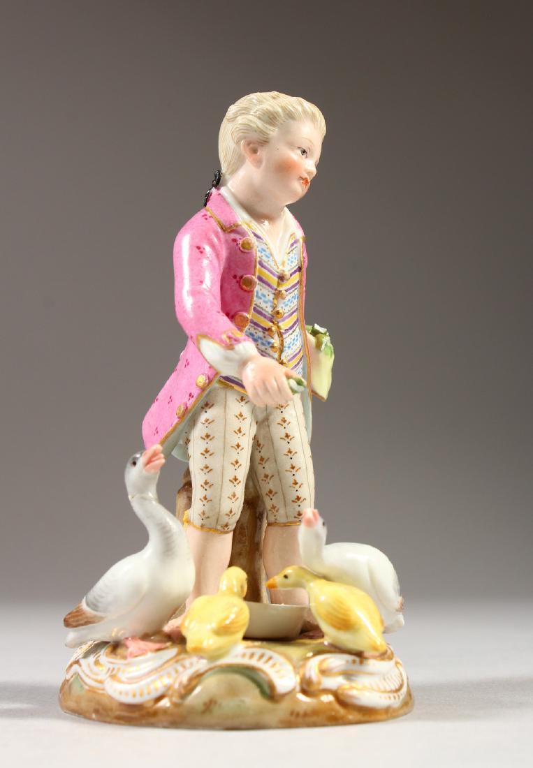 A SMALL 19TH CENTURY MEISSEN PORCELAIN GROUP OF A YOUNG: A SMALL 19TH CENTURY MEISSEN PORCELAIN GROUP OF A YOUNG BOY FEEDING DUCKS. Cross swords mark in blue. Incised No. C41. 9cms high. AF. Arm missing.