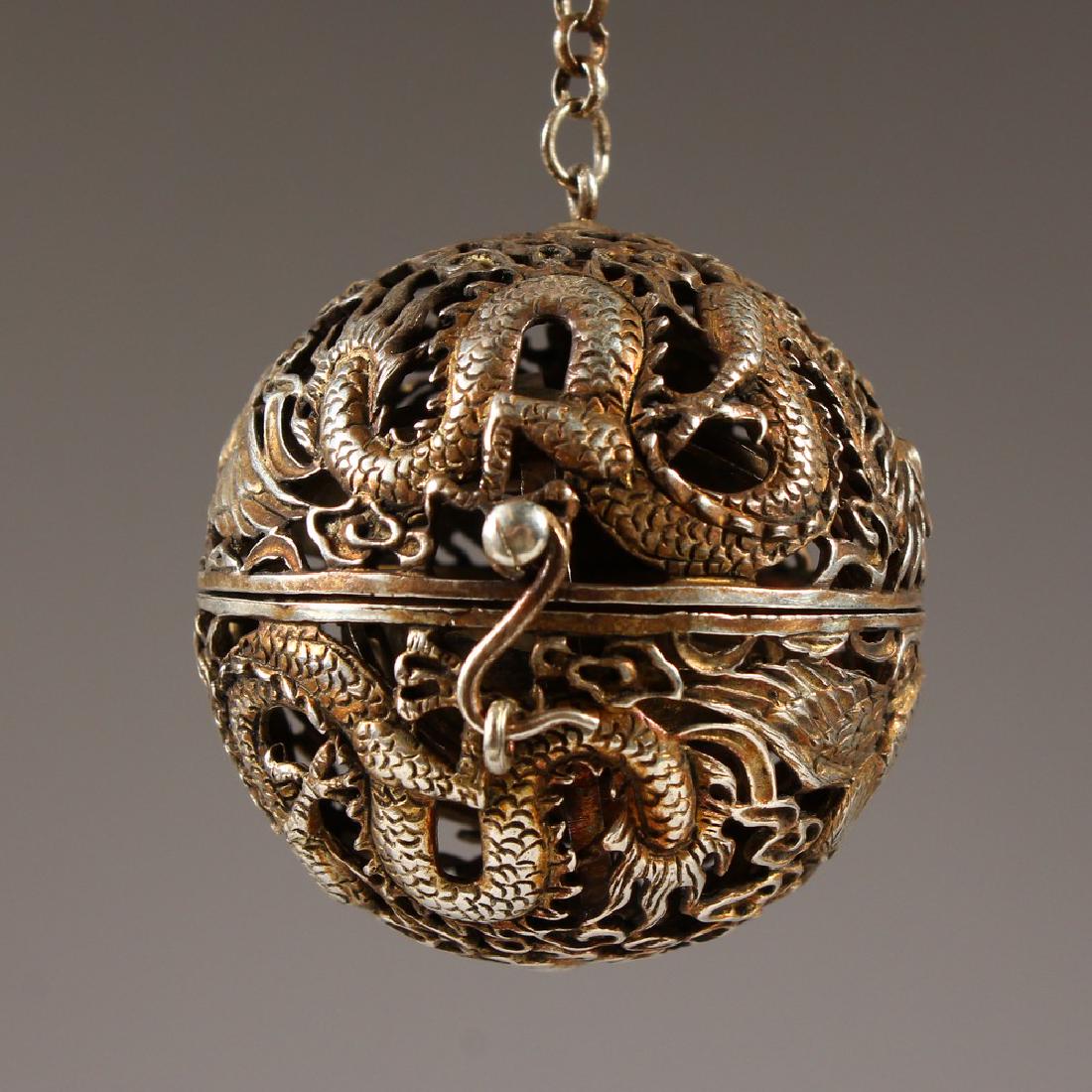 A CHINESE SILVER PIERCED BALL SHAPE CENSER. 5.5cms: A CHINESE SILVER PIERCED BALL SHAPE CENSER. 5.5cms diameter.