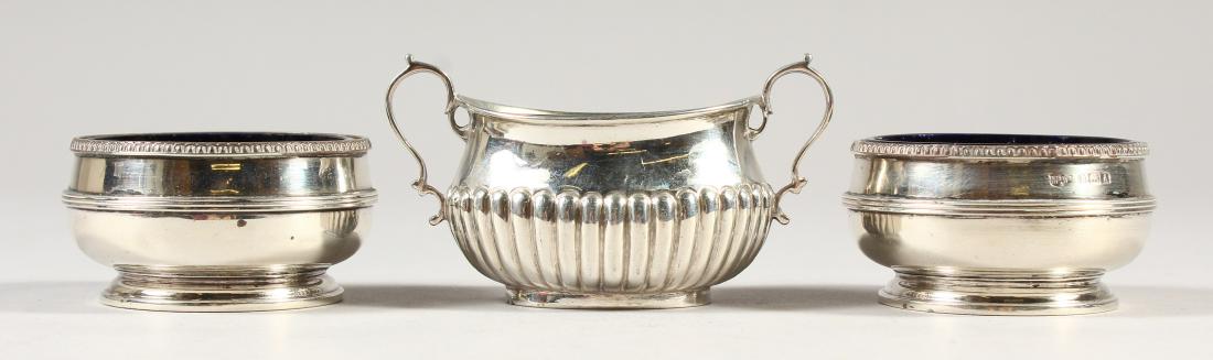 A PAIR OF CIRCULAR SILVER SALTS and an oval salt (3).: A PAIR OF CIRCULAR SILVER SALTS and an oval salt (3).