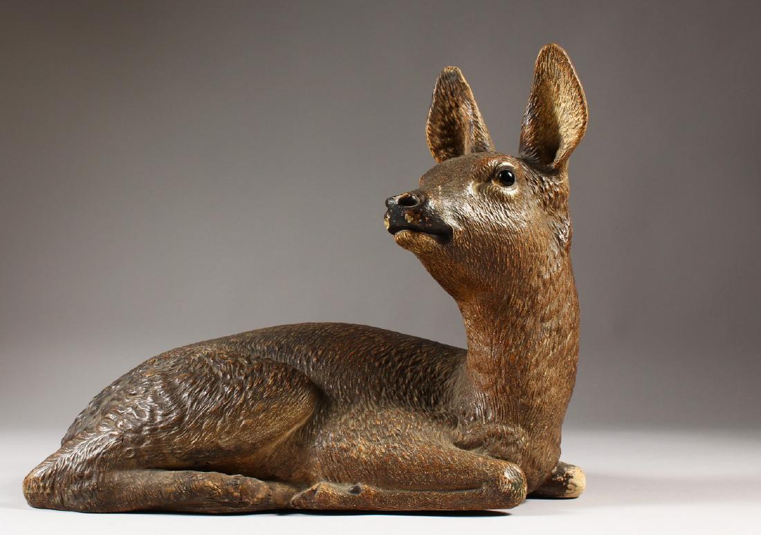 A GOOD TERRACOTTA MODEL OF A YOUNG DEER stamped W. R.: A GOOD TERRACOTTA MODEL OF A YOUNG DEER stamped W. R. I. 26cms high. 30cms long.