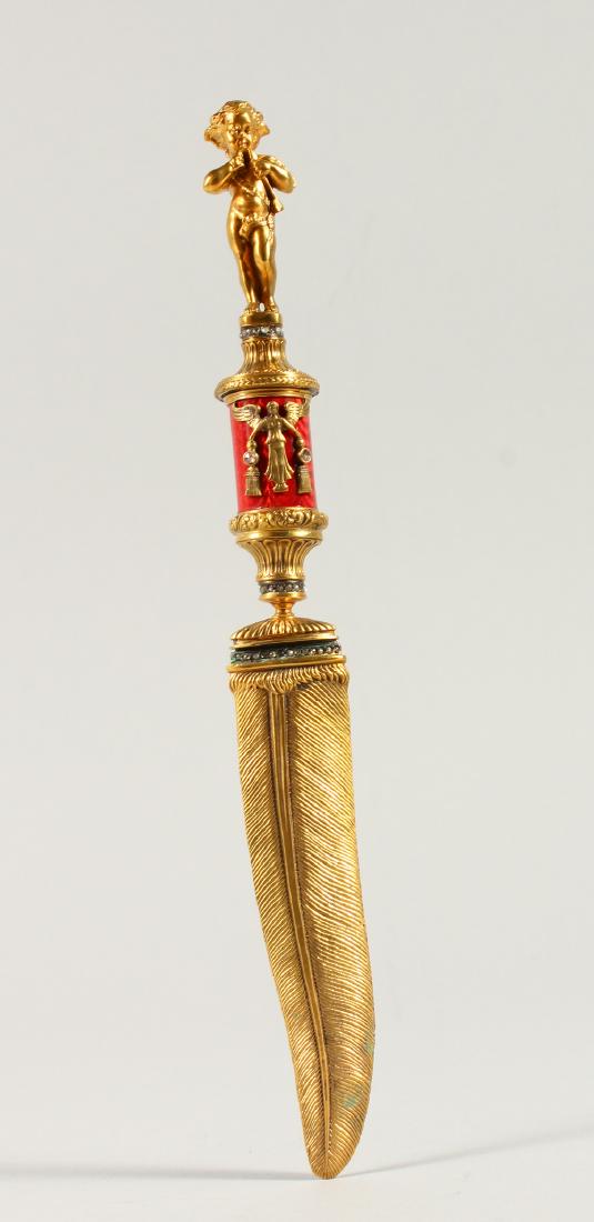 A RUSSIAN SILVER GILT AND ENAMEL LETTER OPENER, with: A RUSSIAN SILVER GILT AND ENAMEL LETTER OPENER, with cherb finial and feather shaped blade. 26.5cms long.