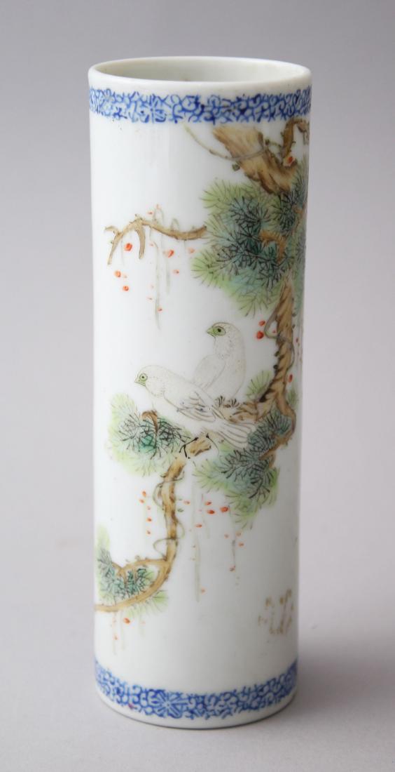 A CHINESE REPUBLICAN BLUE & WHITE CYLINDRICAL PORCELAIN: A CHINESE REPUBLICAN BLUE & WHITE CYLINDRICAL PORCELAIN BRUSH POT, with painted enamel scenes of birds upon trees, the base with a inner foot rim and bearing a iron red four character Qianlong mark, 1