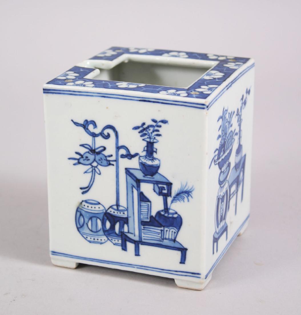 A 19TH CENTURY CHINESE BLUE & WHITE PORCELAIN TEAPOT: A 19TH CENTURY CHINESE BLUE & WHITE PORCELAIN TEAPOT HOLDER, decorated with our different scenes of floral displays, 10.6cm high x 9.1cm square.