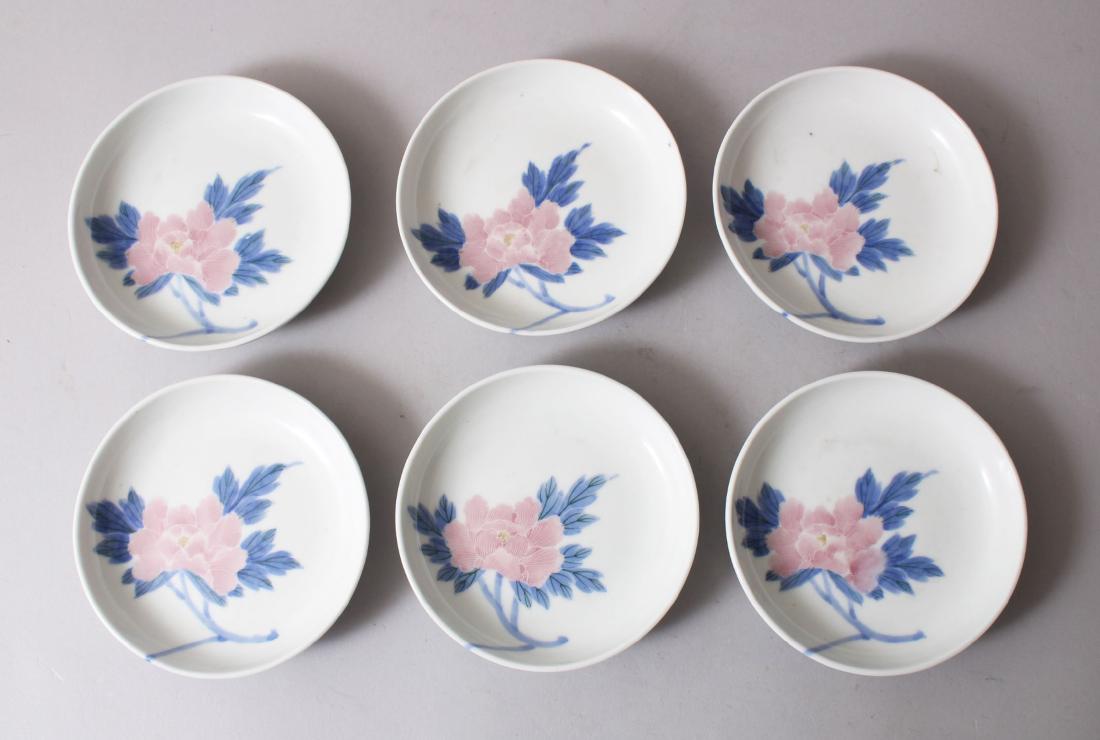 A SET OF SIX JAPANESE LATE MEIJI PORCELAIN DISHES, each: A SET OF SIX JAPANESE LATE MEIJI PORCELAIN DISHES, each decorated with floral scenes, the base with a leaf & flora and bearing a blue underglaze signature, 11.6cm diameter.