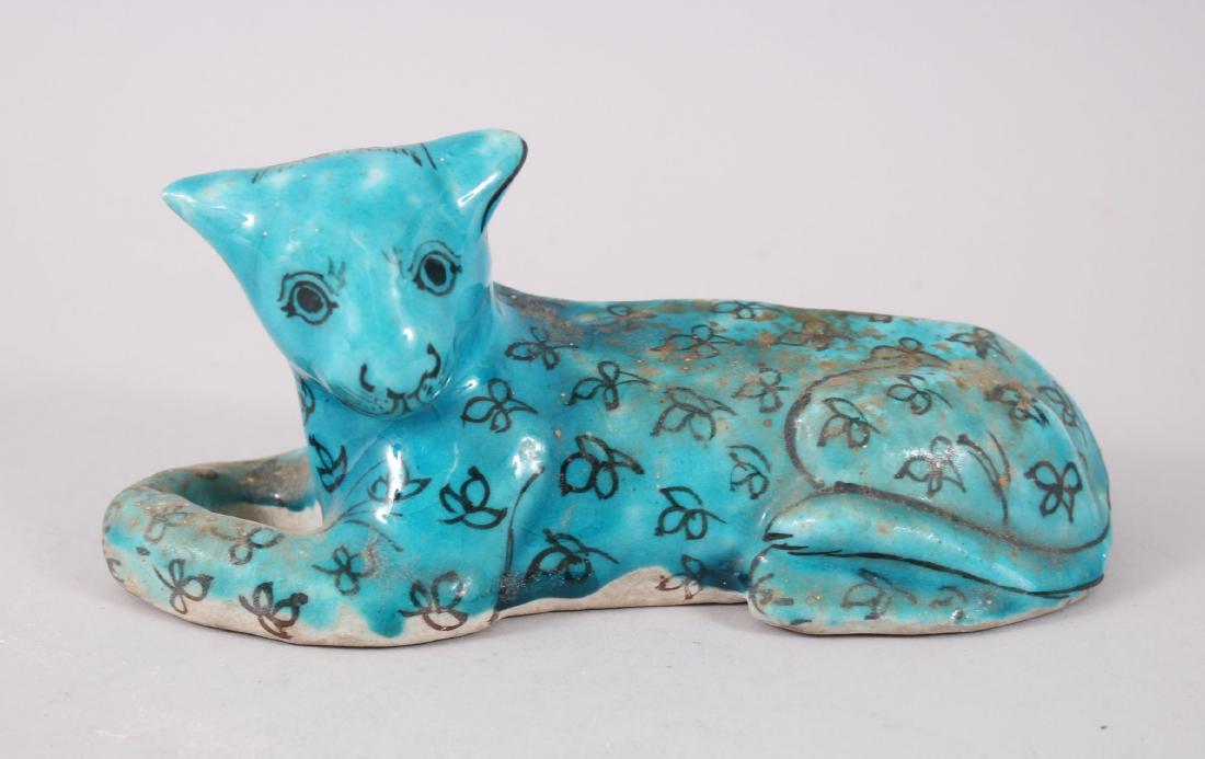 A 19TH CENTURY QAJAR POTTERY RECLINING CAT, 20cm long. (1 of 5)