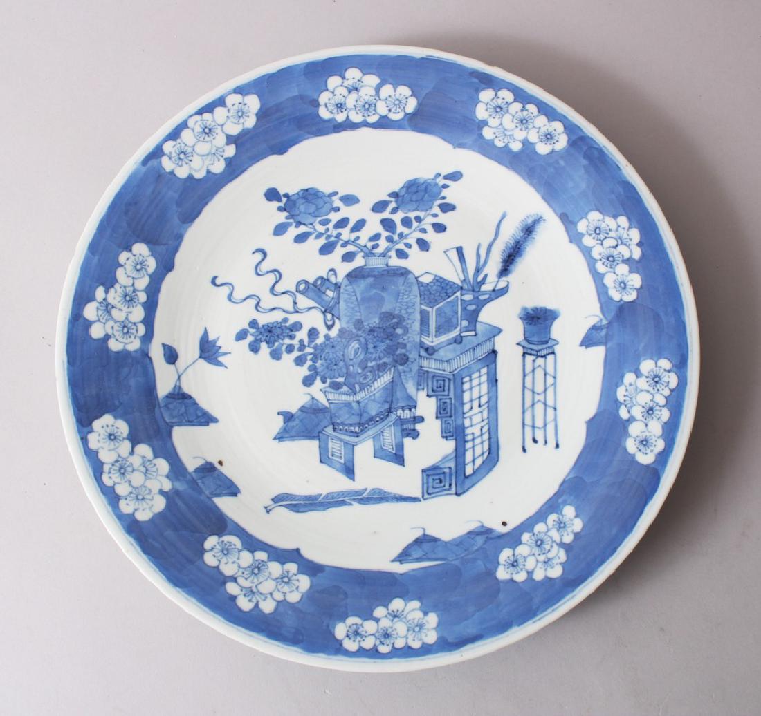 A 19TH CENTURY JAPANESE IMARI / ARITA BLUE & WHITE: A 19TH CENTURY JAPANESE IMARI / ARITA BLUE & WHITE DISH, decorated with arrays of ikebana and prunus blossom borders, 29.5cm.