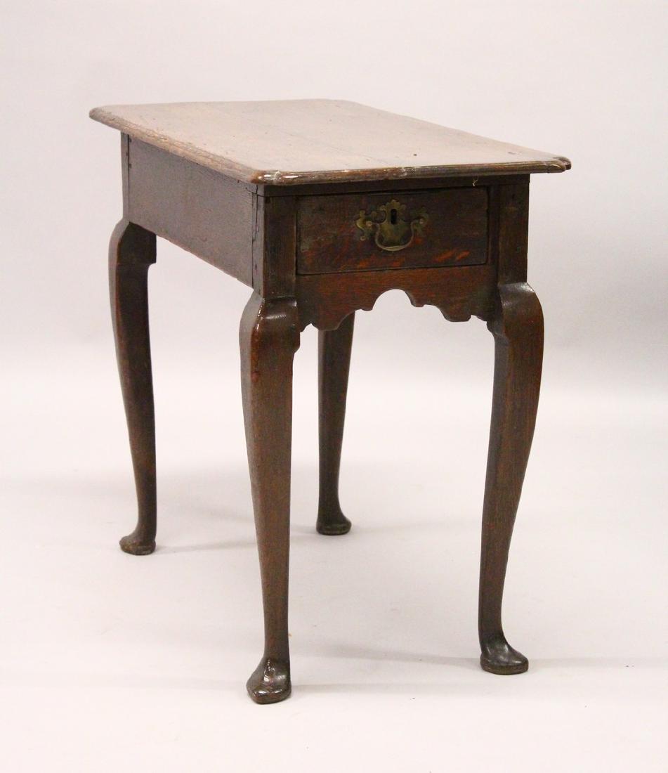 AN 18TH CENTURY OAK TABLE, with a drawer to one end, on: AN 18TH CENTURY OAK TABLE, with a drawer to one end, on cabriole legs, (alterations). 85cm long x 69cm high x 47cm deep.