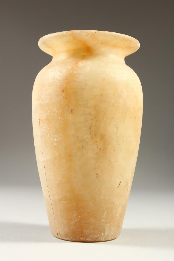 AN EGYPTIAN ALABASTER VASE. 19cms high.: AN EGYPTIAN ALABASTER VASE. 19cms high.