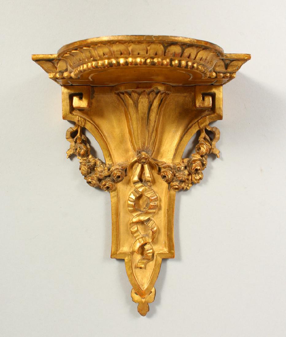 A GILDED WALL BRACKET. 20cms long.: A GILDED WALL BRACKET. 20cms long.