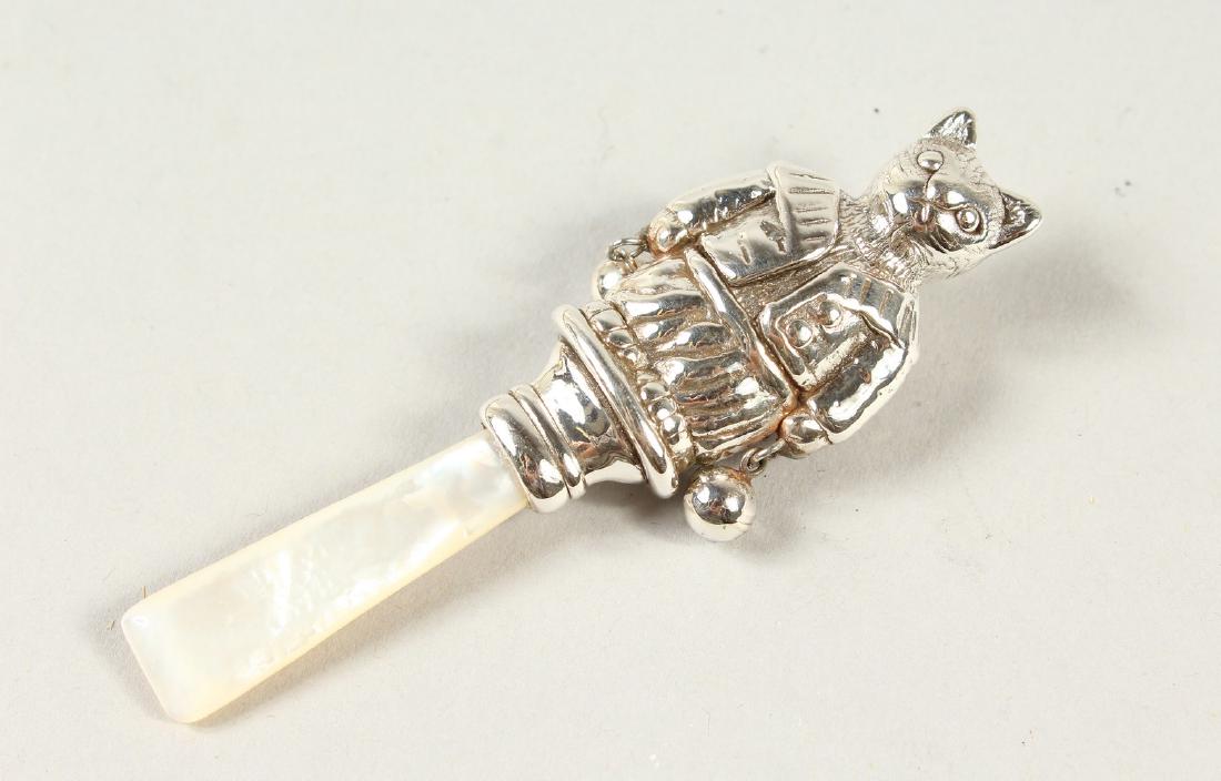 A SILVER AND MOTHER-OF-PEARL CAT RATTLE.: A SILVER AND MOTHER-OF-PEARL CAT RATTLE.