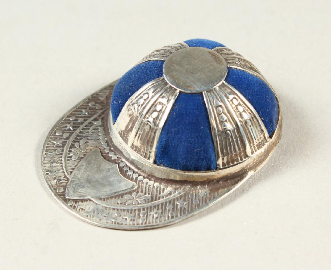 A SILVER NOVELTY JOCKEY CAP PIN CUSHION.: A SILVER NOVELTY JOCKEY CAP PIN CUSHION.