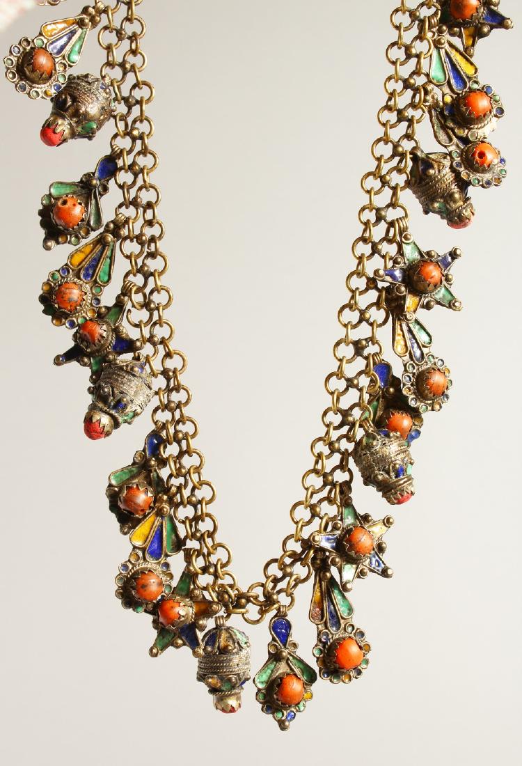AN ISLAMIC SILVER METAL AND CORAL NECKLACE.: AN ISLAMIC SILVER METAL AND CORAL NECKLACE.