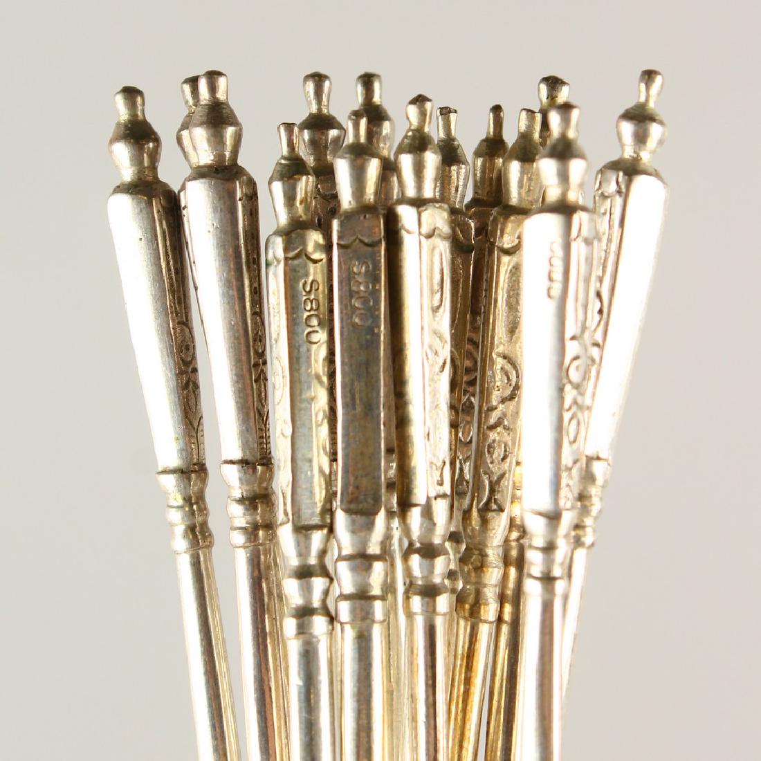 A SET OF FOURTEEN .800 SILVER LONG HANDLED TEASPOONS.: A SET OF FOURTEEN .800 SILVER LONG HANDLED TEASPOONS.