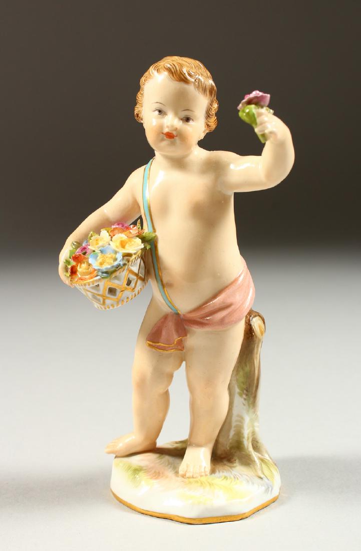 A SMALL 19TH CENTURY MEISSEN CHERUB standing holding a: A SMALL 19TH CENTURY MEISSEN CHERUB standing holding a basket of flowers. Cross swords mark in blue. Incised A64. 14cms high.