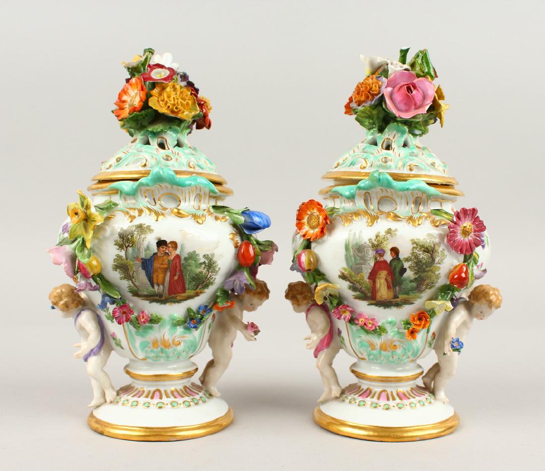 A SUPERB PAIR OF MEISSEN PORCELAIN FLOWER ENCRUSTED: A SUPERB PAIR OF MEISSEN PORCELAIN FLOWER ENCRUSTED PIERCED URNS AND COVERS, painted with reverse panels of figures and flowers, with flowers and cupids in relief. Cross swords mark in blue. Incised N