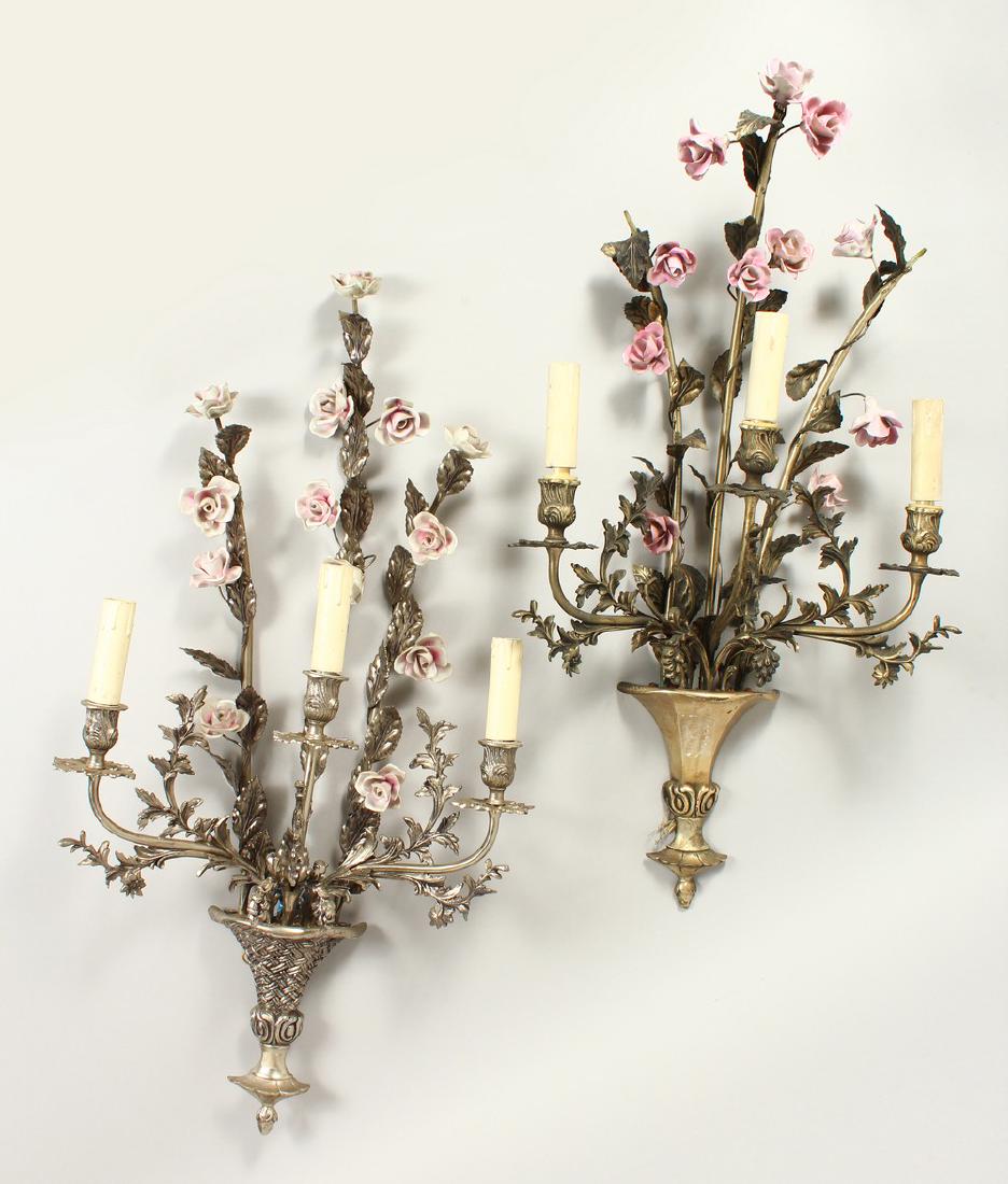 TWO VERY SIMILAR FLORAL WALL SCONCES, with three: TWO VERY SIMILAR FLORAL WALL SCONCES, with three branches and porcelain flowers. 72cms long.