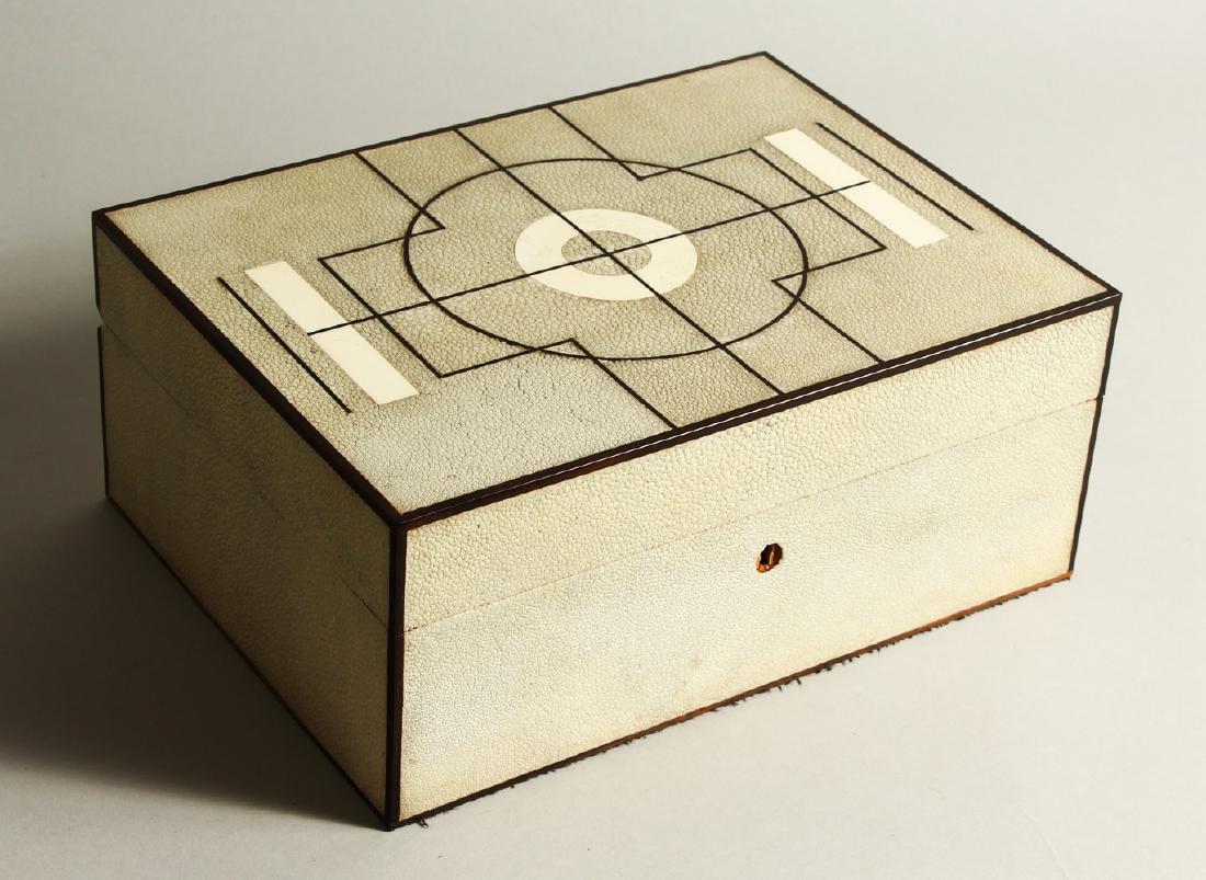 A SUPERB SHAGREEN COVERED HUMIDOR, the top and sides: A SUPERB SHAGREEN COVERED HUMIDOR, the top and sides with light grey shagreen, the top with a circular design. 31cm long x 24cm wide x 13cm high.
