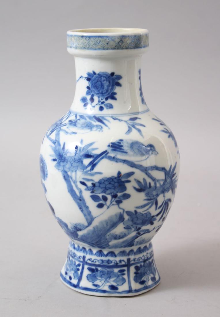 A 19TH CENTURY CHINESE BLUE & WHITE PORCELAIN VASE, the: A 19TH CENTURY CHINESE BLUE & WHITE PORCELAIN VASE, the body decorated with floral decoration, the base bearing a six character kangxi mark, 22.5cm high x 12.5cm wide.