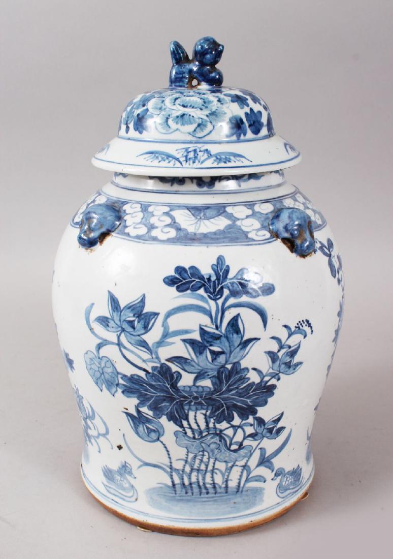 A LATE 19TH CENTURY / EARLY 20TH CENTURY CHINESE BLUE &: A LATE 19TH CENTURY / EARLY 20TH CENTURY CHINESE BLUE & WHITE PORCELAIN JAR & COVER, the body with four moulded lion dog heads, borders of flora and bats, the body with displays of native flora, the l