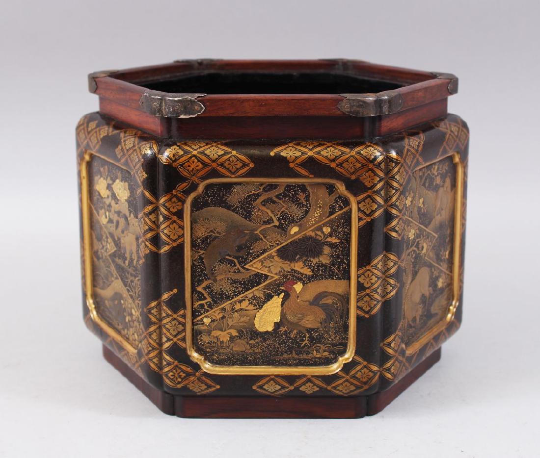 A LOVELY JAPANESE MEIJI PERIOD CARVED HARDWOOD AND: A LOVELY JAPANESE MEIJI PERIOD CARVED HARDWOOD AND LACQUER JARDINIERE / PLANTER, the carved hardwood hexagonal formed jardiniere with silver butterfly formed mounts, the main body with six different l