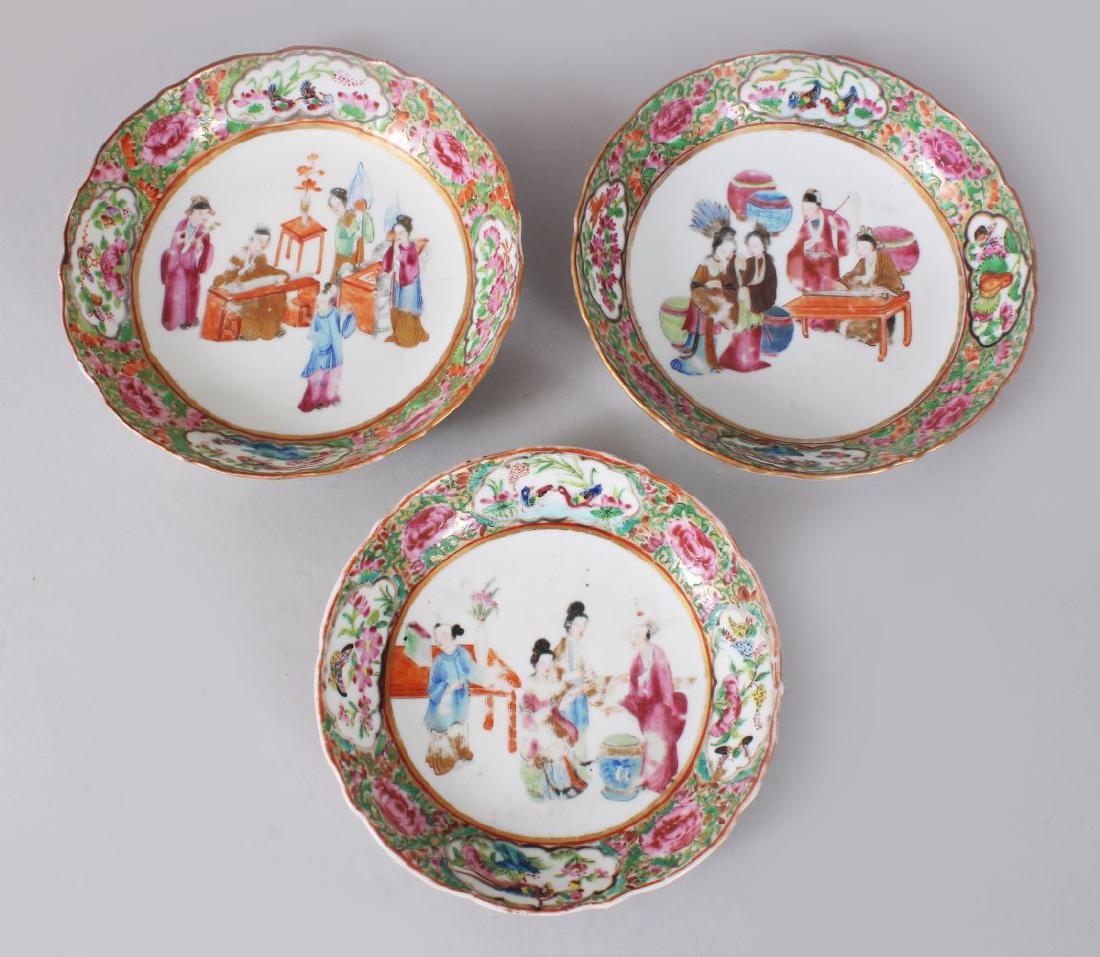 THREE 19TH CENTURY CHINESE CANTON FAMILLE ROSE: THREE 19TH CENTURY CHINESE CANTON FAMILLE ROSE PORCELAIN BOWLS, each with a central painting of figures exterior, surrounded by panels of butterflies, geese and phoenix birds amongst native flora, lar