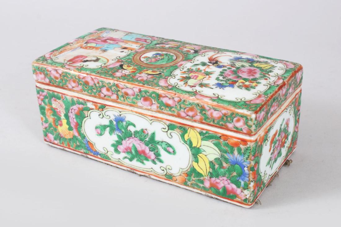 A 19TH CENTURY CHINESE CANTON FAMILLE ROSE PORCELAIN: A 19TH CENTURY CHINESE CANTON FAMILLE ROSE PORCELAIN BOX & COVER, the box with typical decoration of figures interior & birds and butterflies amongst flora, 8cm high x 18.3cm wide x 9cm deep.