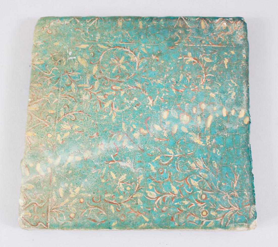 A RARE 12TH-13TH CENTURY PERSIAN GREEN GLAZED SQUARE: A RARE 12TH-13TH CENTURY PERSIAN GREEN GLAZED SQUARE TILE with leaf decoration, 23cm x 23cm.