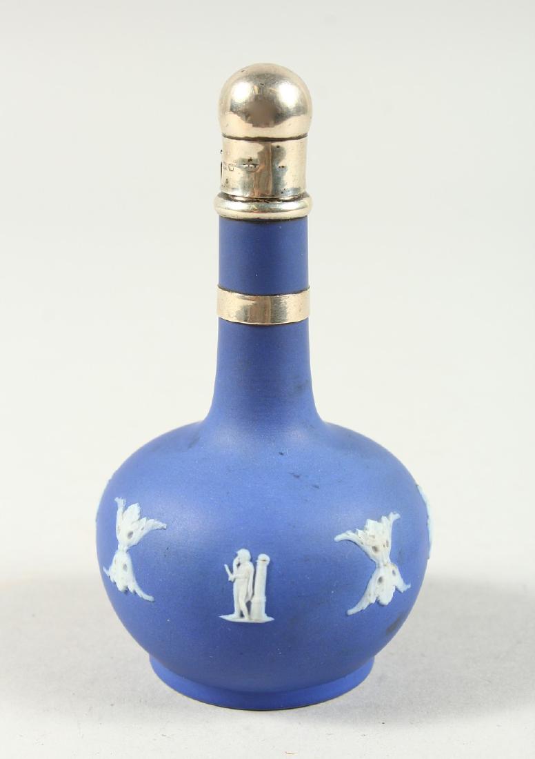 A WEDGWOOD BLUE AND WHITE JASPER WARE BOTTLE VASE with: A WEDGWOOD BLUE AND WHITE JASPER WARE BOTTLE VASE with silver top, on a chain. 10.5cms high.