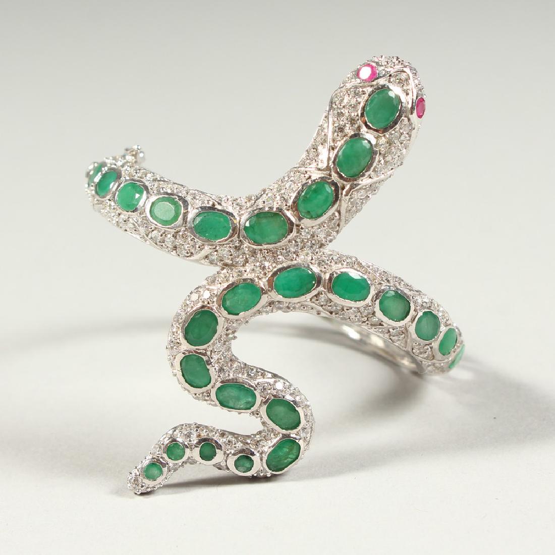 A SILVER AND REAL EMERALD SNAKE BANGLE with ruby eyes.: A SILVER AND REAL EMERALD SNAKE BANGLE with ruby eyes.
