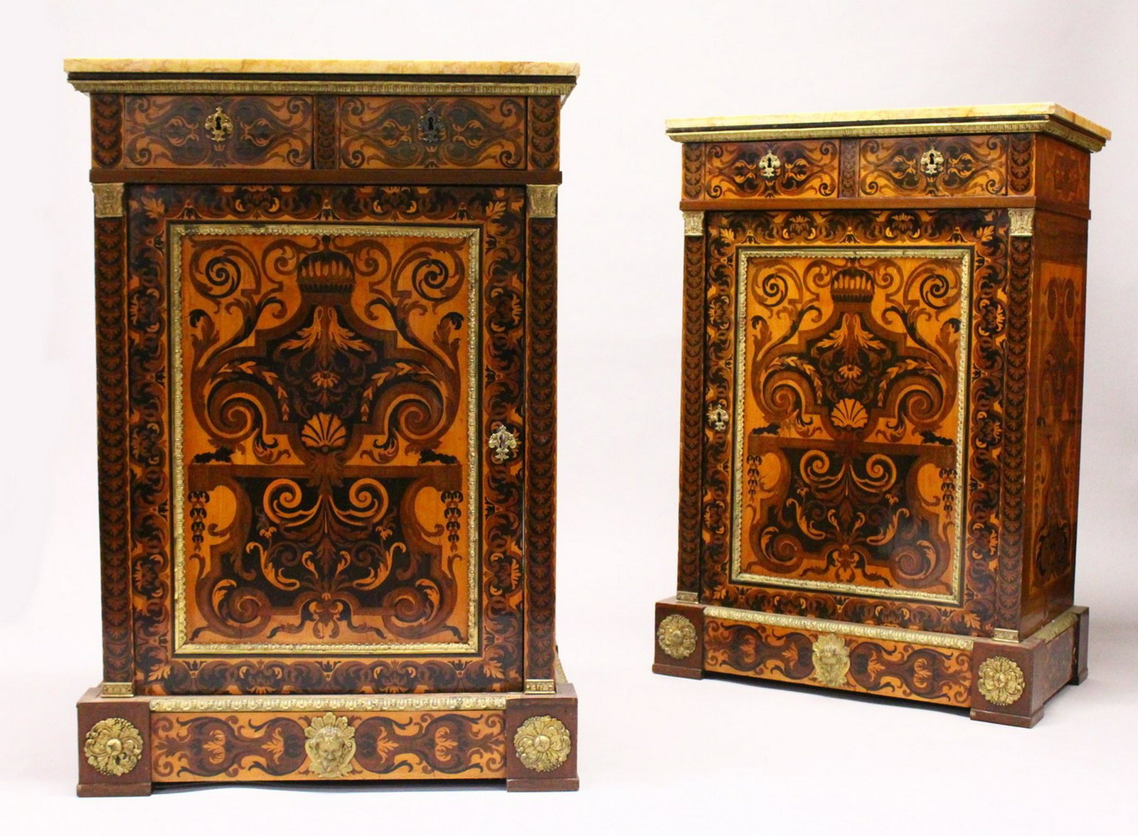 A GOOD PAIR OF 19TH CENTURY MARQUETRY PIER CABINETS,: A GOOD PAIR OF 19TH CENTURY MARQUETRY PIER CABINETS, with ormolu mounts, variegated yellow marble tops over a pair of drawers and a cupboard door, on a plinth base. 3ft 6ins high x 2ft 5ins wide x 1ft