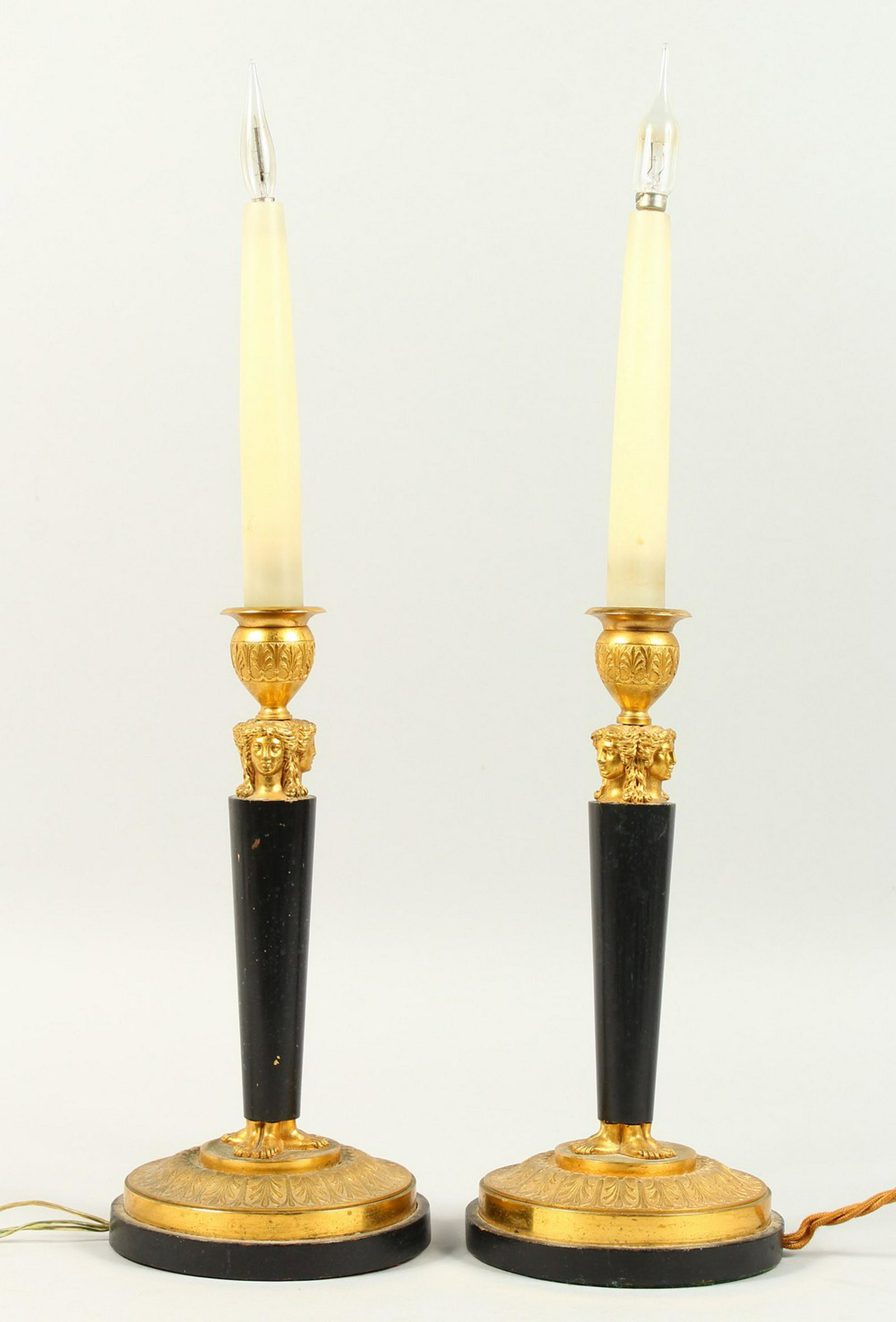 A PAIR OF THOMAS HOPE DESIGN BRONZE AND ORMOLU CIRCULAR: A PAIR OF THOMAS HOPE DESIGN BRONZE AND ORMOLU CIRCULAR STICKS, converted to electricity. 11ins high.