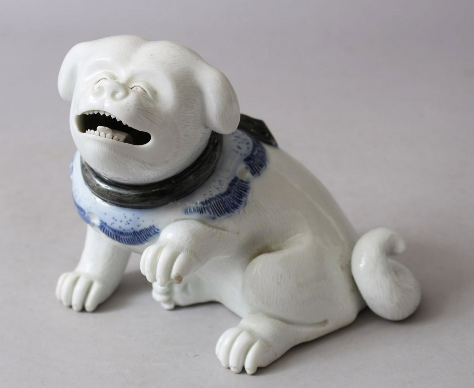 A JAPANESE MEIJI PERIOD HIRADO MODEL OF A SHI-SHI,: A JAPANESE MEIJI PERIOD HIRADO MODEL OF A SHI-SHI, 11.5cm high.