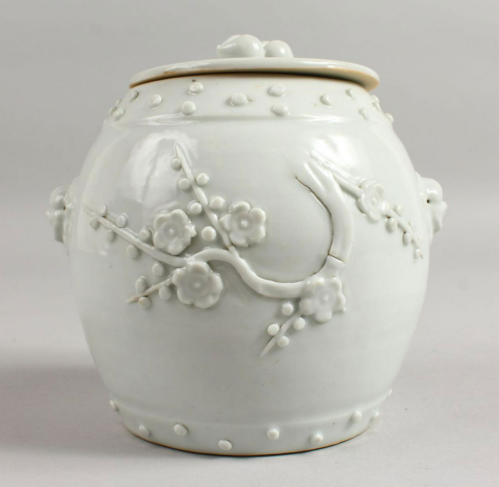 A CHINESE CELADON POT AND COVER with prunus blossom. (1 of 9)