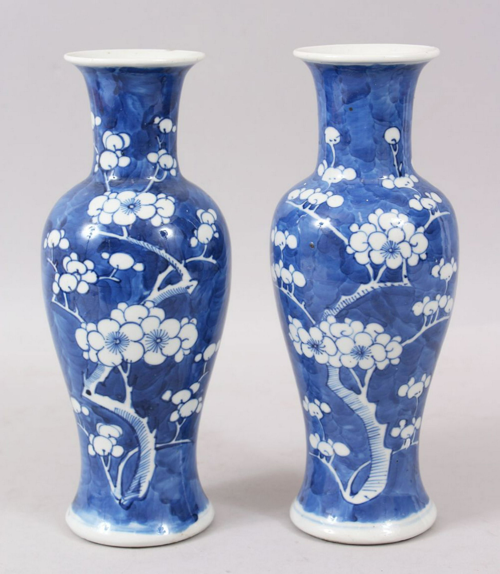 A PAIR OF LATE 19TH CENTURY CHINESE BLUE & WHITE PRUNUS: A PAIR OF LATE 19TH CENTURY CHINESE BLUE & WHITE PRUNUS PORCELAIN VASES, of baluster form, 25cm high.