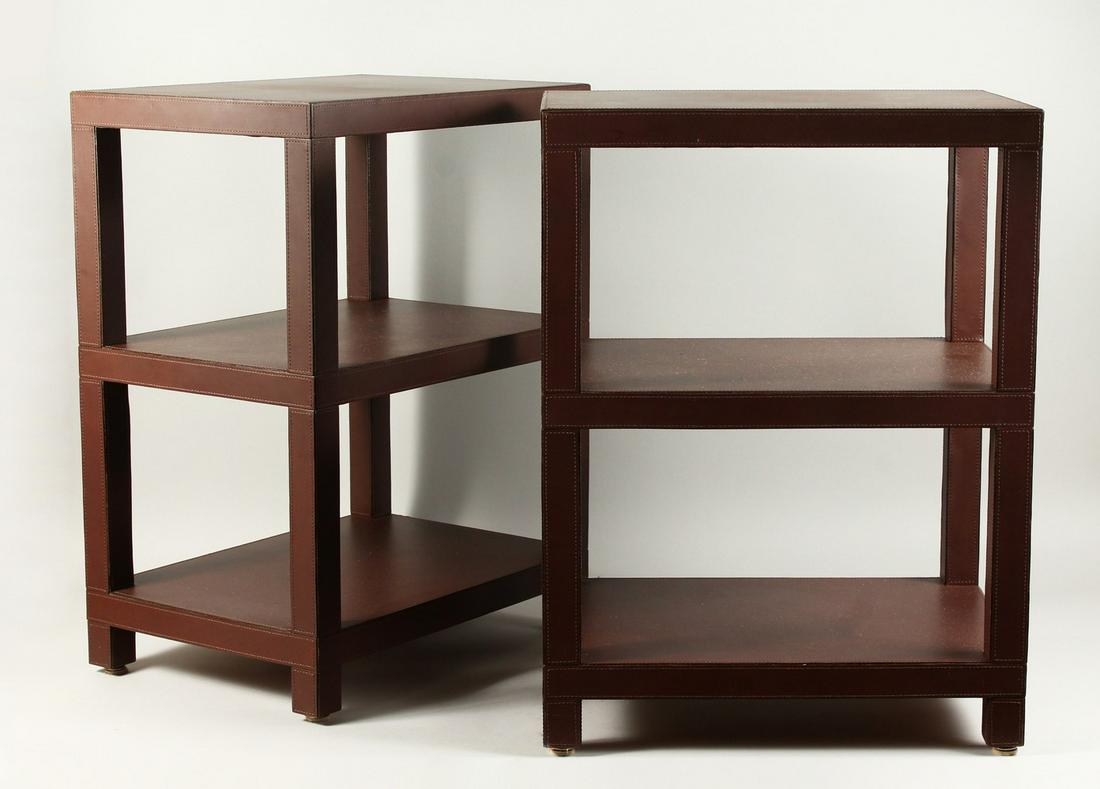 DOMINIC CHAMBON, A GOOD PAIR OF LEATHER COVERED THREE: DOMINIC CHAMBON, A GOOD PAIR OF LEATHER COVERED THREE TIER OCCASIONAL TABLES. 48cms wide x 34cms deep x 65cms high.