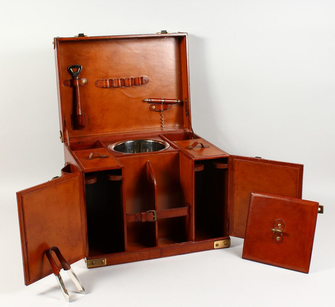A LEATHER PICNIC HAMPER, with fitted interior. 17.5ins: A LEATHER PICNIC HAMPER, with fitted interior. 17.5ins wide.