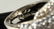 A LARGE SILVER CZ SET BUCKLE RING. - 3
