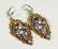 A PAIR OF GILT METAL CUT STEEL AND OPAL EARRINGS. 2ins