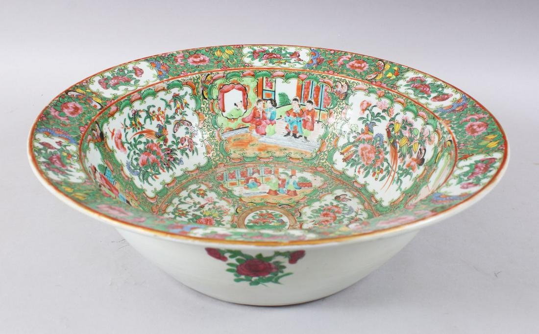 A LARGE 19TH CENTURY CHINESE CANTON FAMILLE ROSE: A LARGE 19TH CENTURY CHINESE CANTON FAMILLE ROSE PORCELAIN BASIN, decorated with panels of figures both interior and within landscapes, further decorated with birds amongst trees and butterflies with 