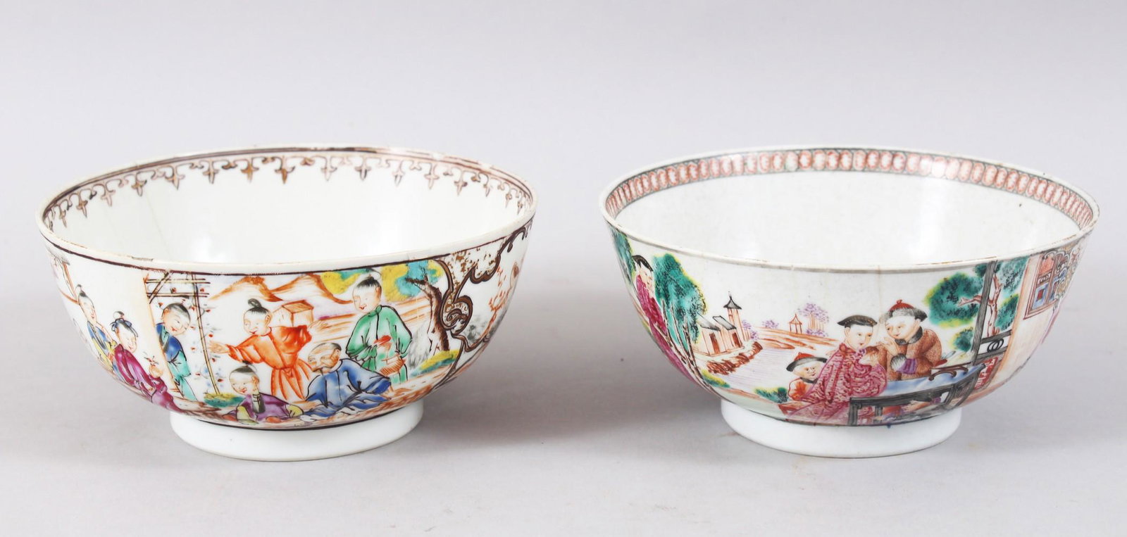 TWO 18TH CENTURY CHINESE FAMILLE ROSE MANDARIN: TWO 18TH CENTURY CHINESE FAMILLE ROSE MANDARIN PORCELAIN BOWLS, decorated with scenes of figures amongst village scenes, 14cm diameter each.