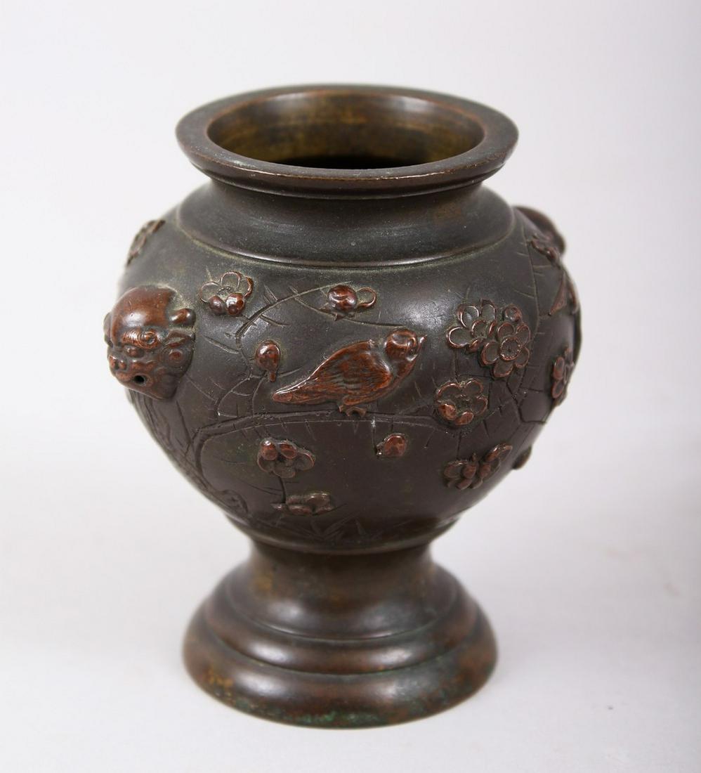 A SMALL JAPANESE LATE MEIJI PERIOD BRONZE & MIXED METAL: A SMALL JAPANESE LATE MEIJI PERIOD BRONZE & MIXED METAL TWIN HANDLES VASE, the body with twin lion dog head handles, with birds sat amongst cherry blossom, 8cm high x 7.2cm wide.