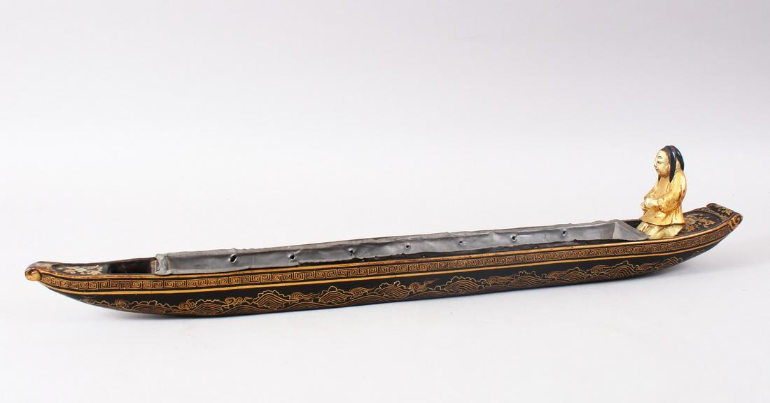 A GOOD JAPANESE EDO PERIOD LACQUER OIL CLOCK BOAT, the: A GOOD JAPANESE EDO PERIOD LACQUER OIL CLOCK BOAT, the rear with a gold lacquer figure with a paddle, the boat decorated with waves to simulate water, with a soft metal liner, 61cm long
