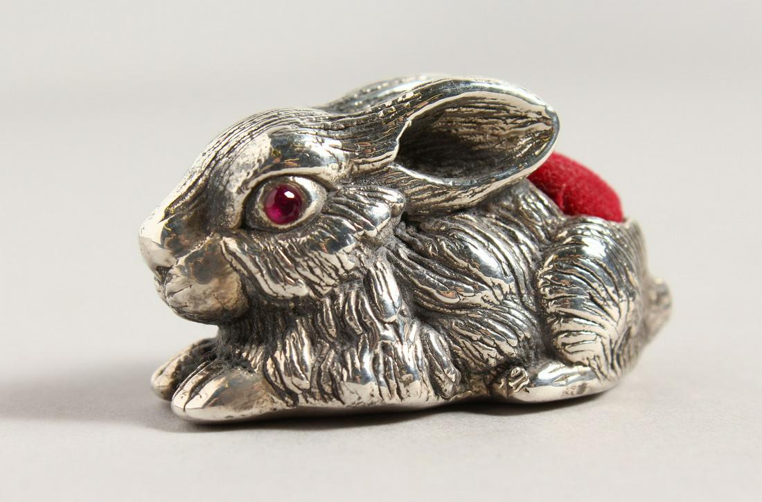 A CAST SILVER RABBIT PIN CUSHION. 2ins long.: A CAST SILVER RABBIT PIN CUSHION. 2ins long.